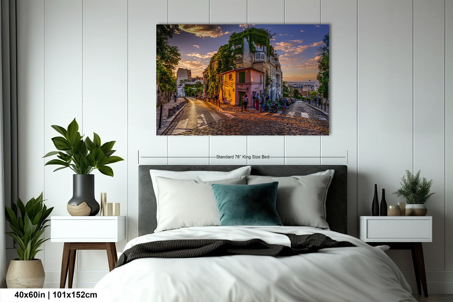 a bedroom with a bed and a painting on the wall