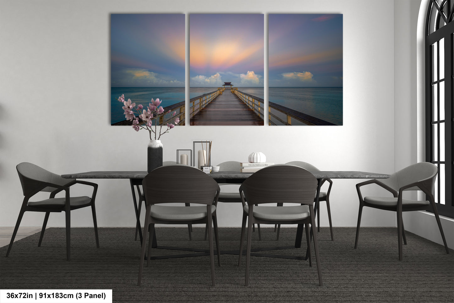 a dining room table with four chairs and a painting on the wall