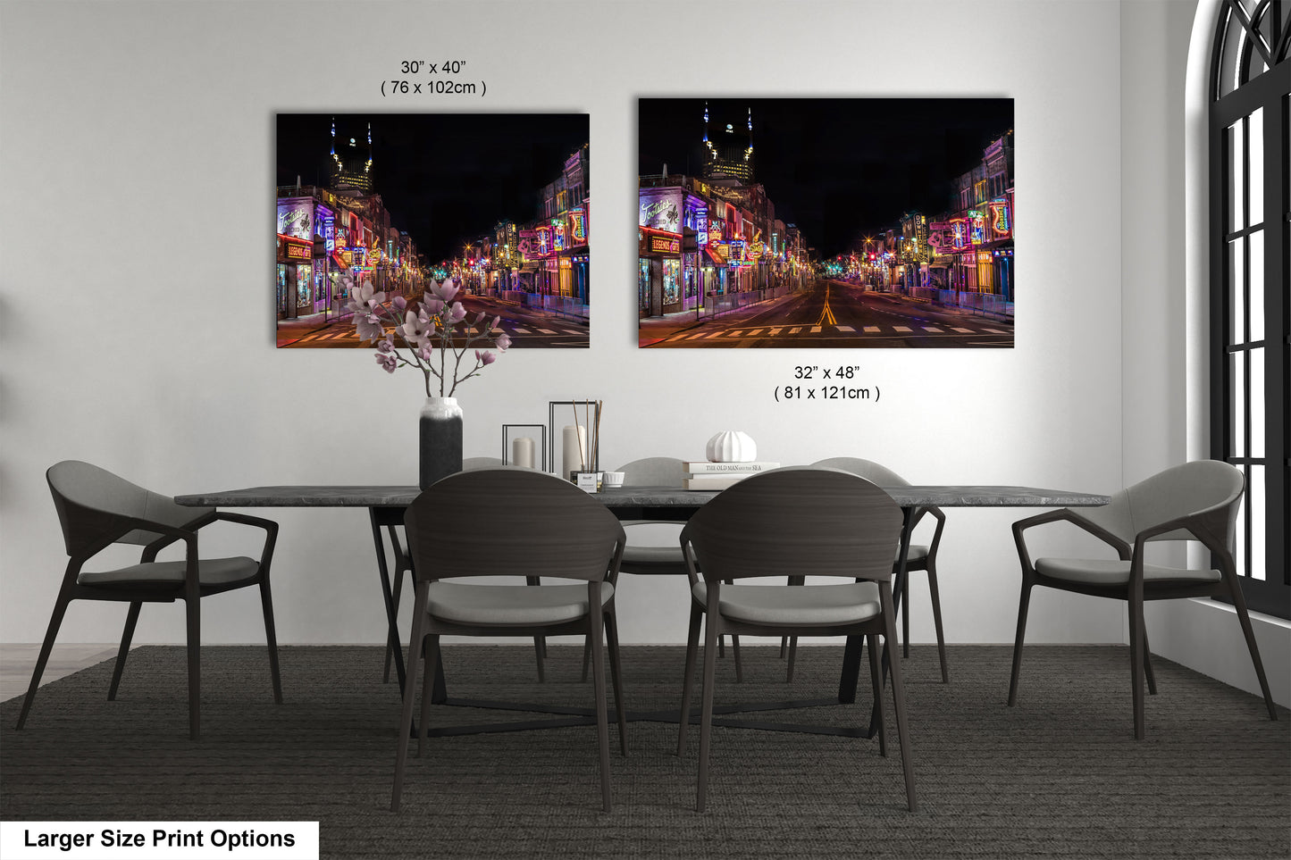 a dining table with four chairs and a vase with flowers
