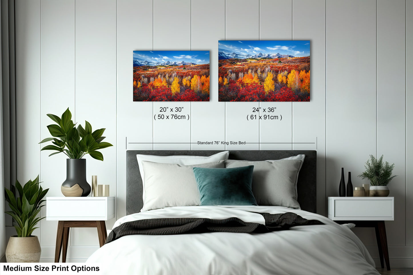 a bedroom with a bed and two paintings on the wall