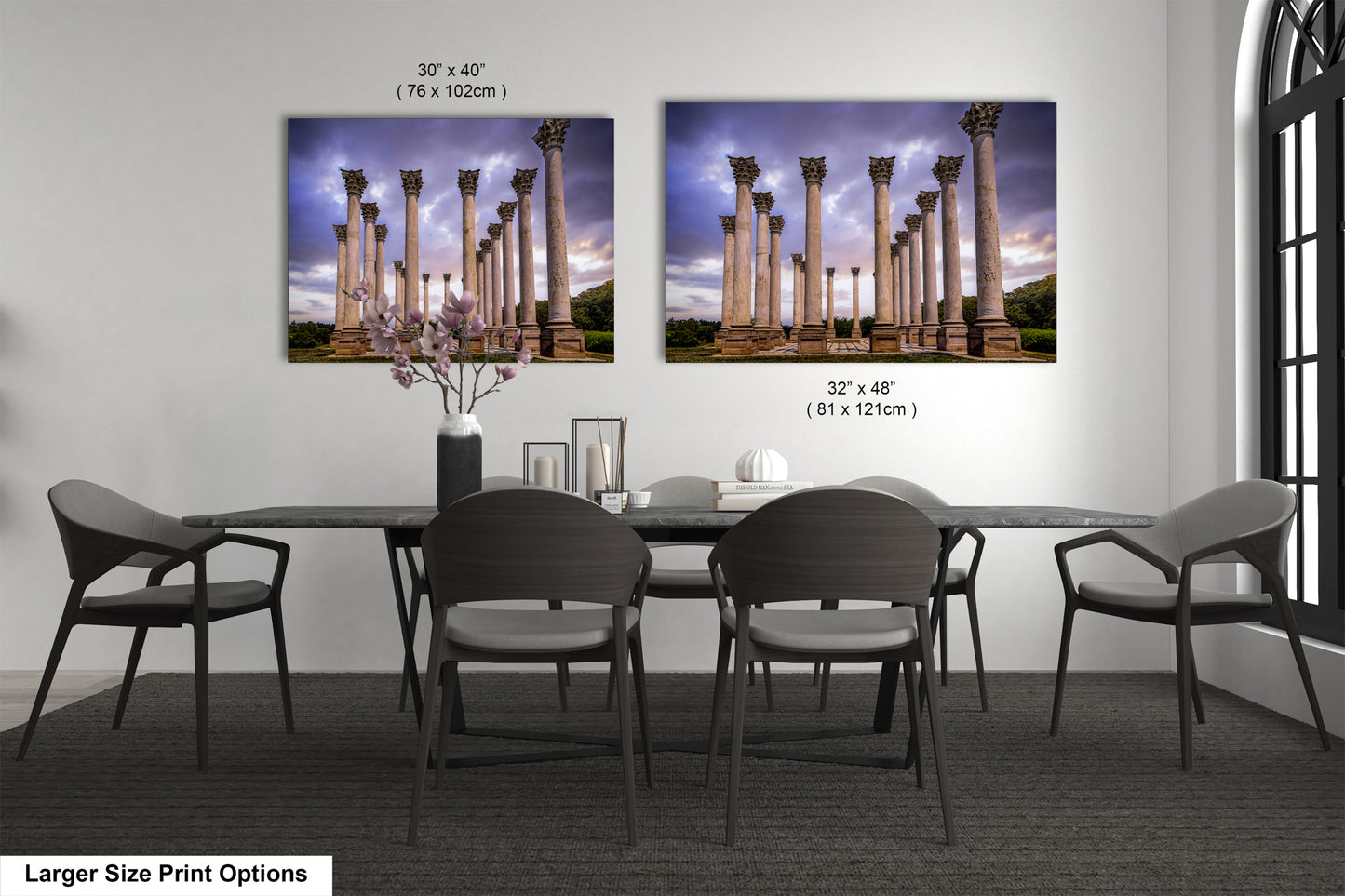 a dining room table with four chairs and a vase with flowers