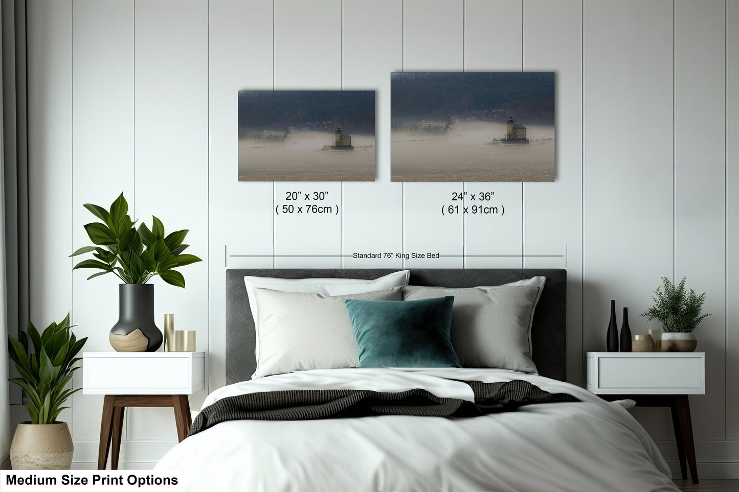 a bed with a white comforter and two pictures on the wall above it