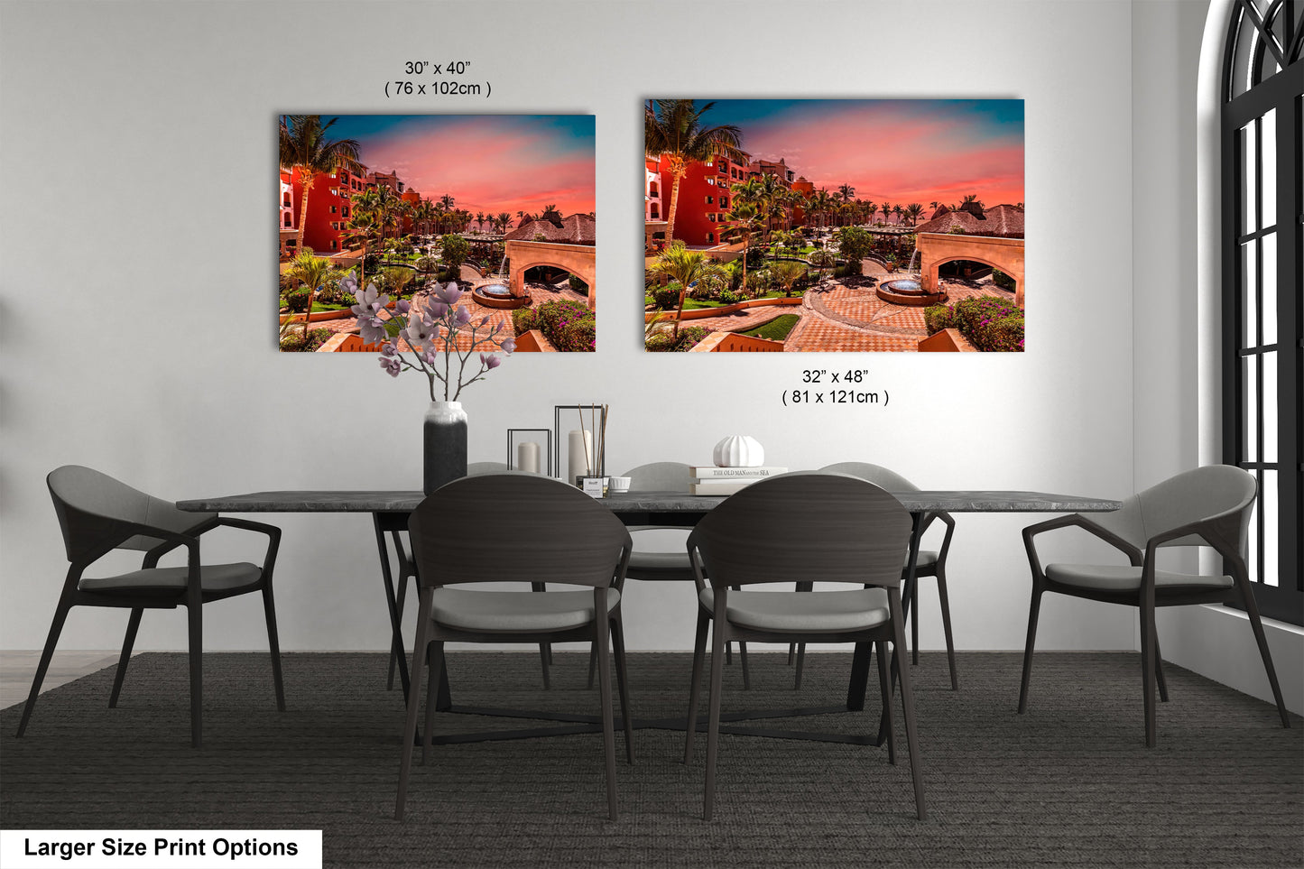 a dining room table with four chairs and a vase of flowers