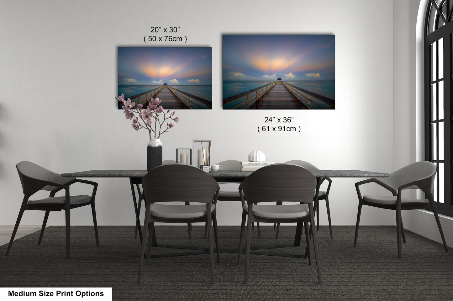 a dining table with four chairs and a vase of flowers