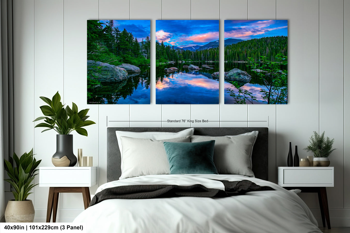 a bedroom with a bed and two paintings on the wall