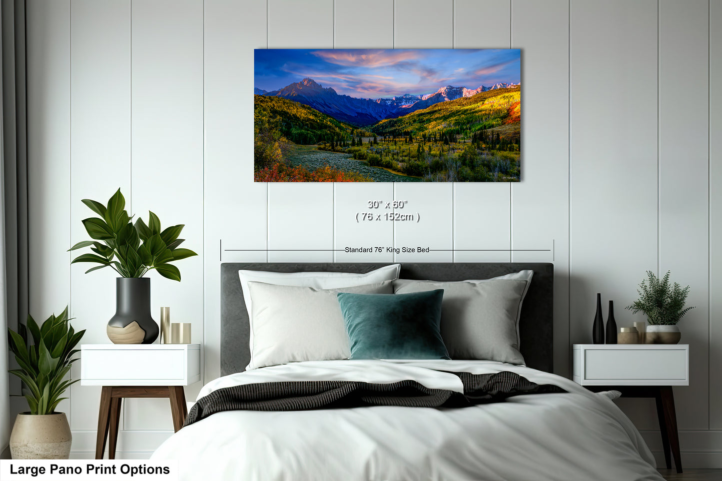 a bedroom with a bed and a painting on the wall