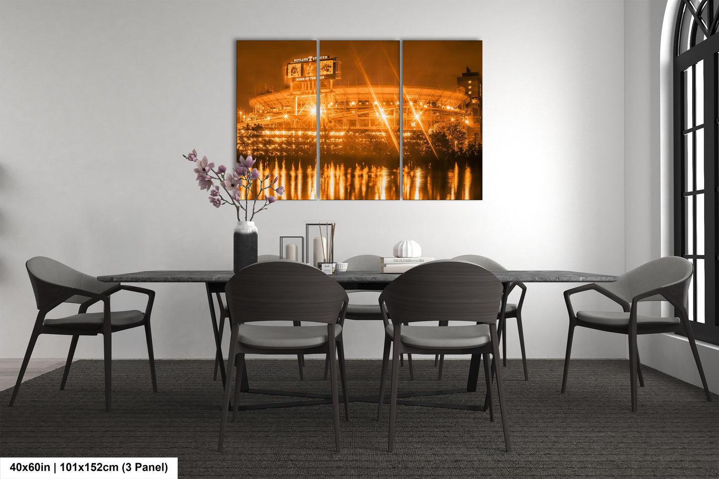 a dining room table with chairs and a painting on the wall