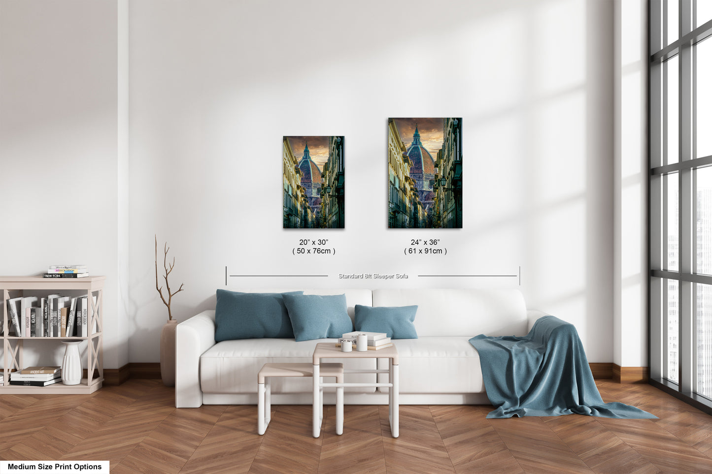 a living room with a white couch and two paintings on the wall