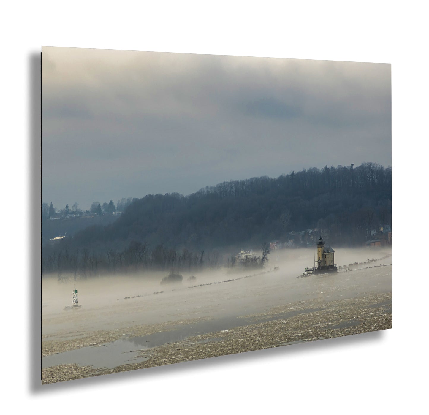 a foggy river with a lighthouse in the distance