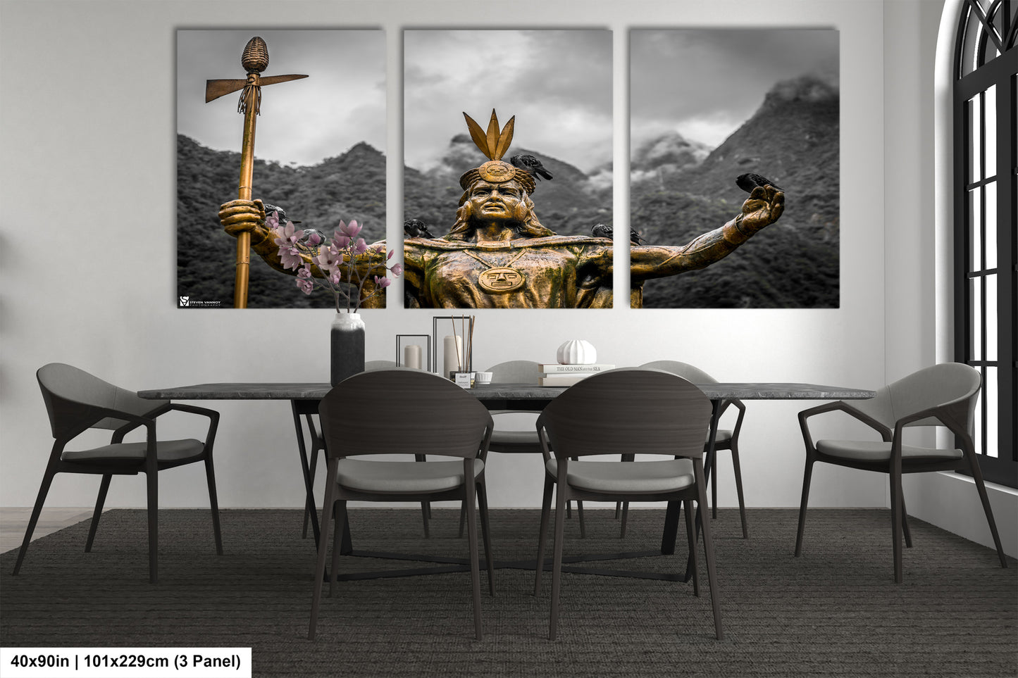 a dining room table with chairs and paintings on the wall