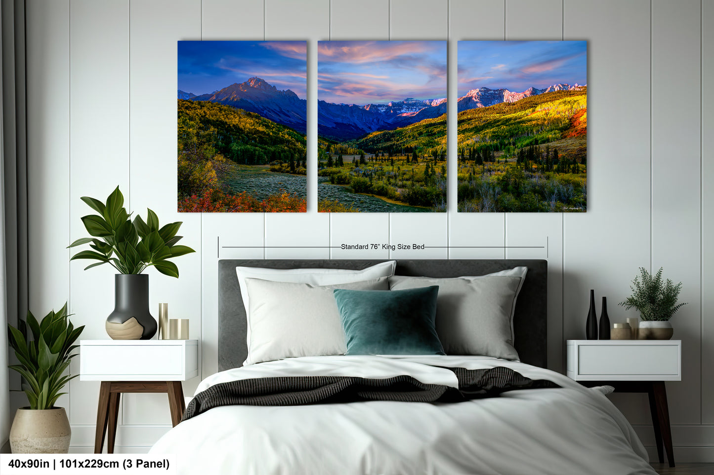 a bedroom with a bed and two paintings on the wall