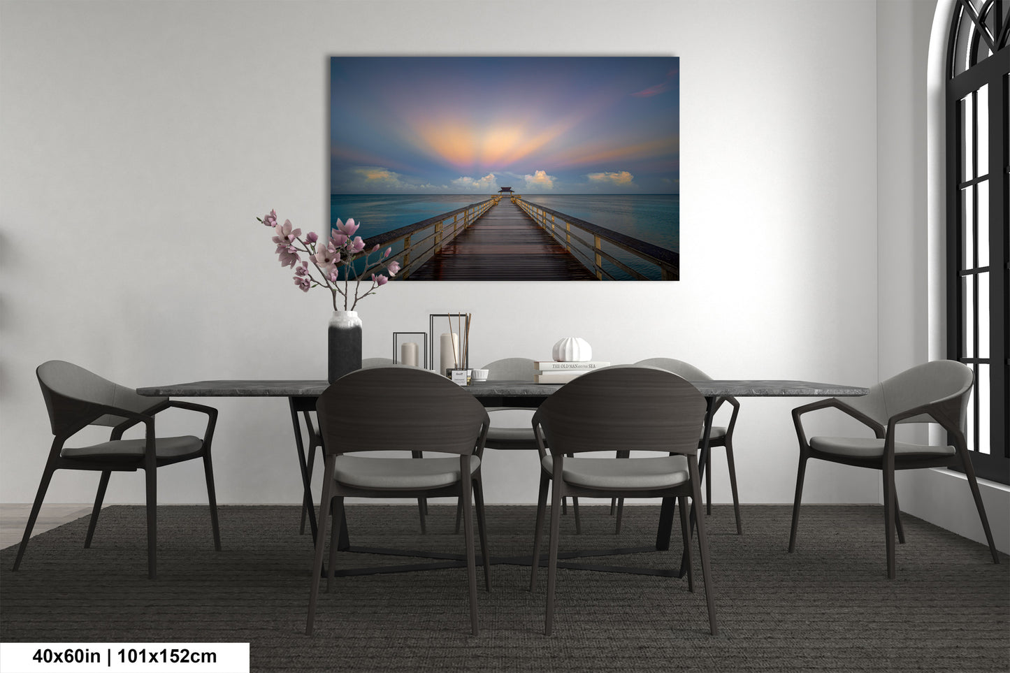 a dining room table with chairs and a painting on the wall