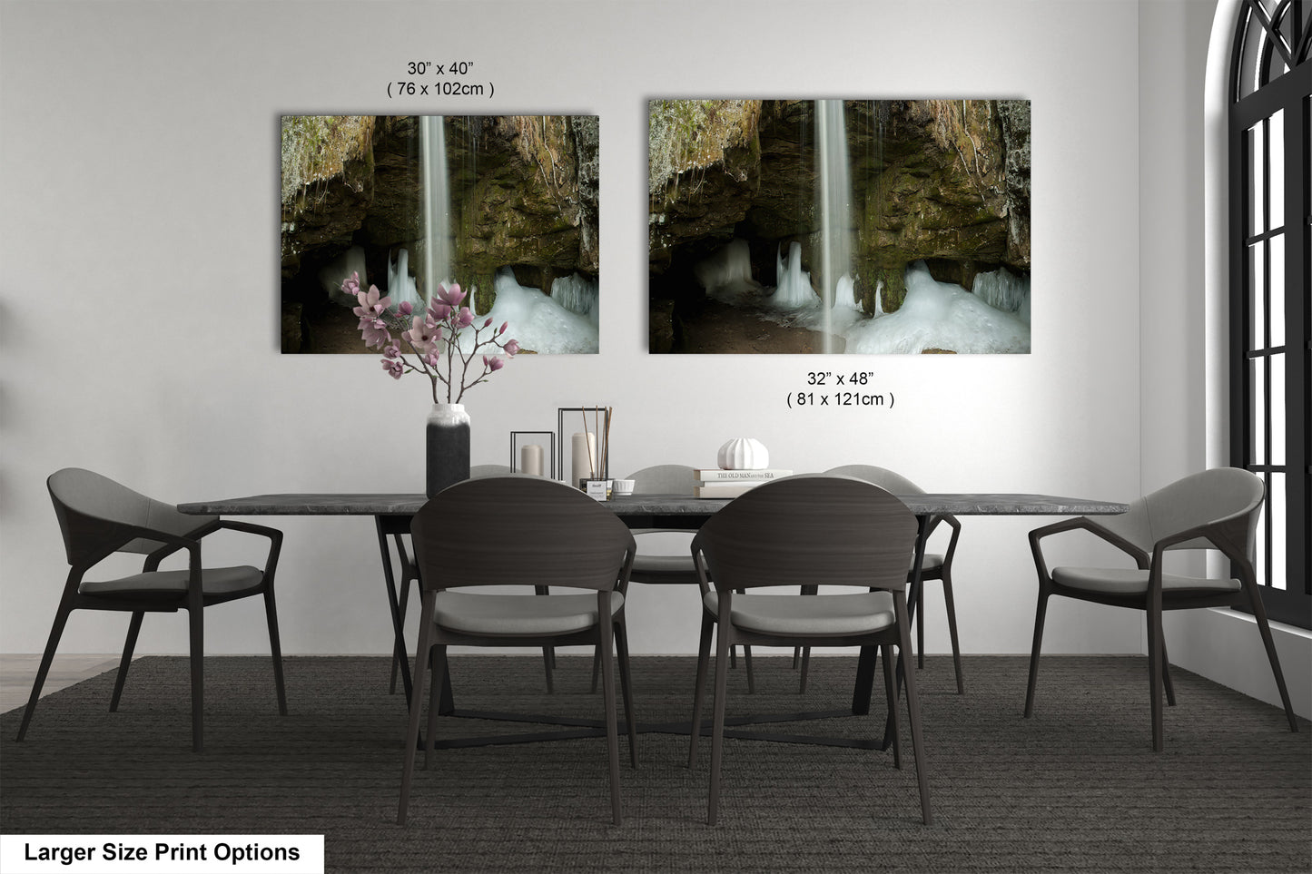 a dining room table with chairs and a vase of flowers