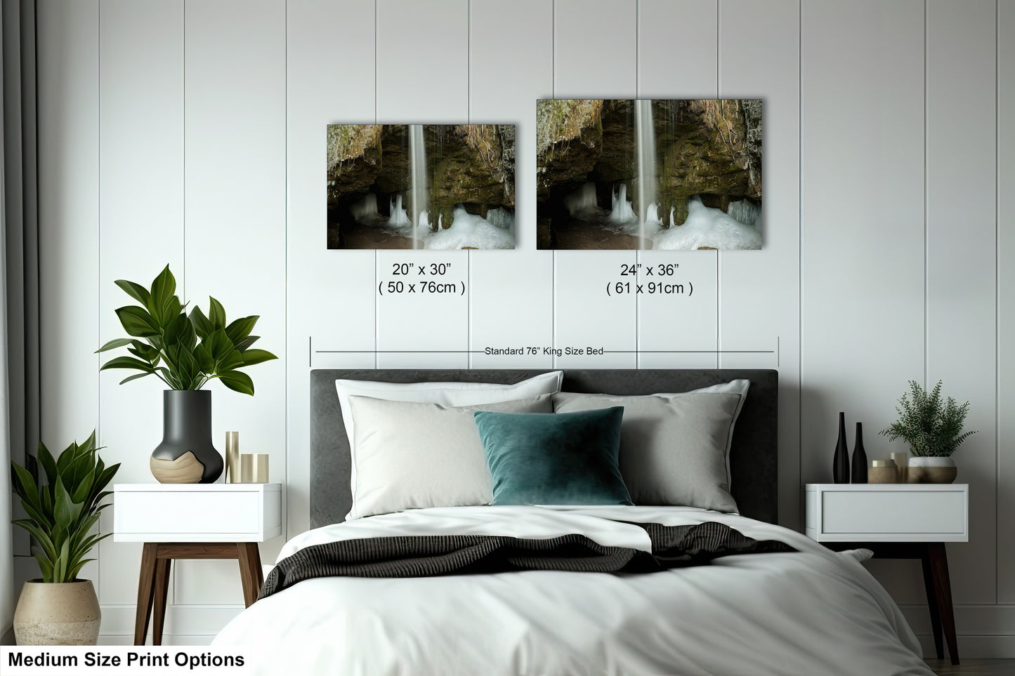 a bed with a white comforter and two pictures on the wall above it