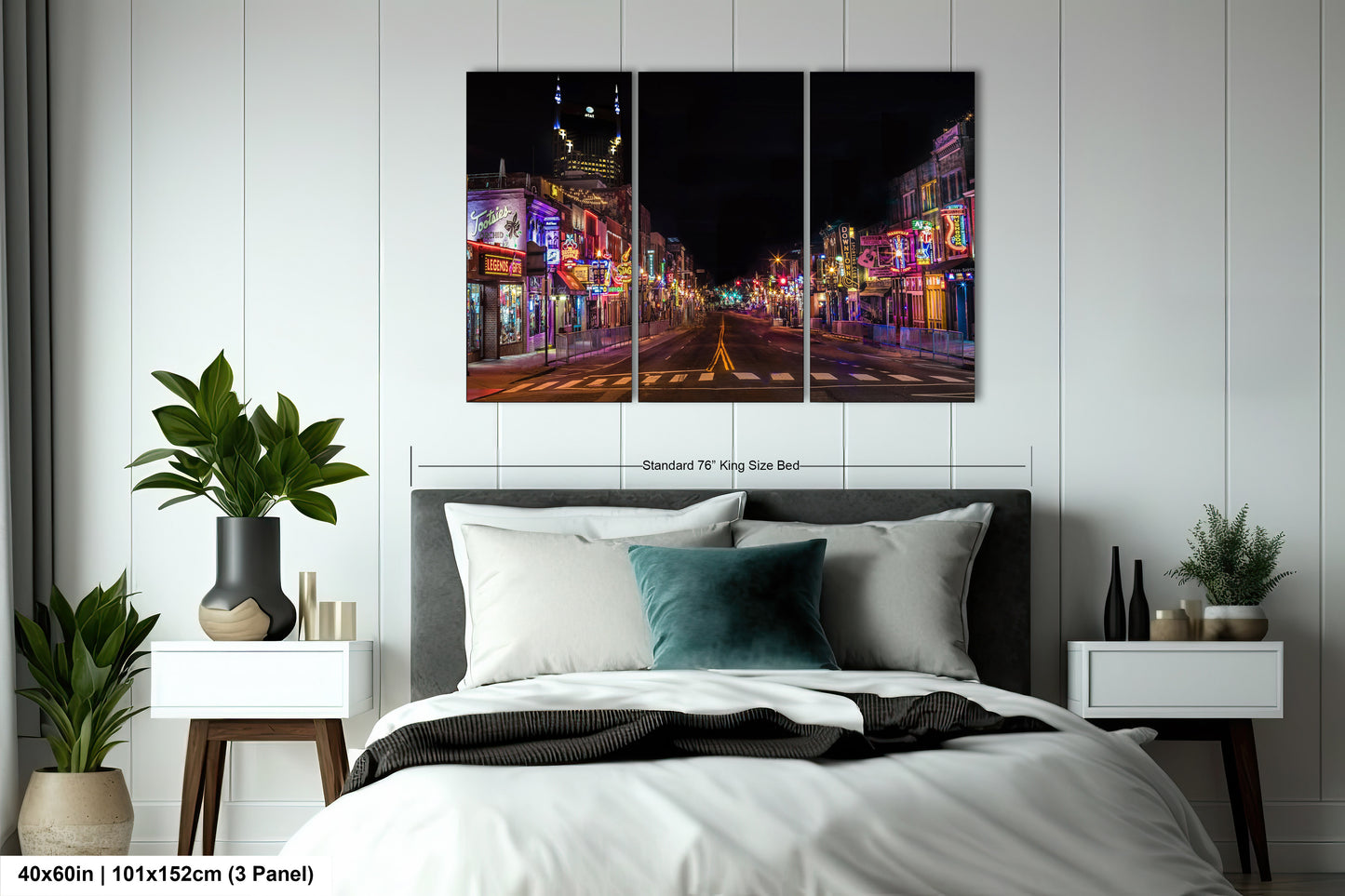 a bedroom with a bed and two paintings on the wall