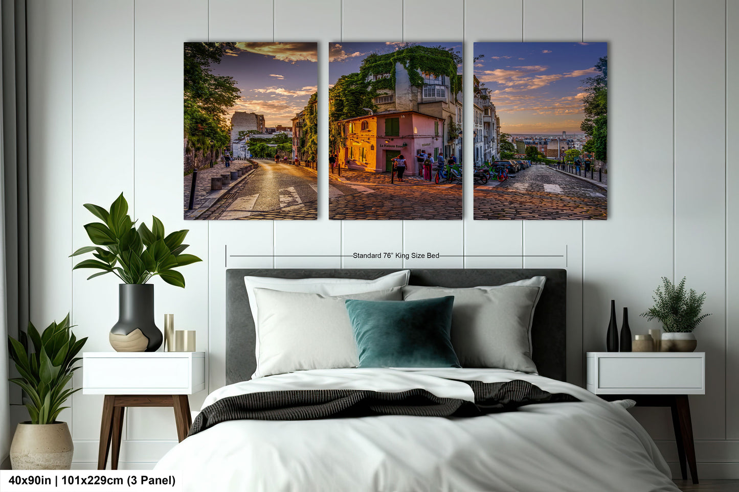 a bedroom with a bed and two paintings on the wall