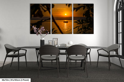 a dining room table with four chairs and a vase of flowers