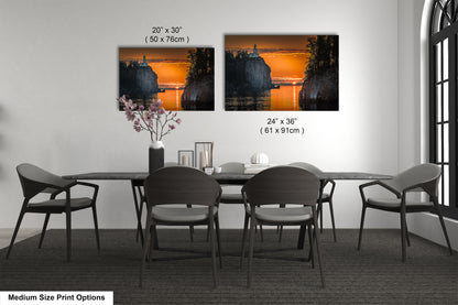 a dining table with four chairs and a vase of flowers