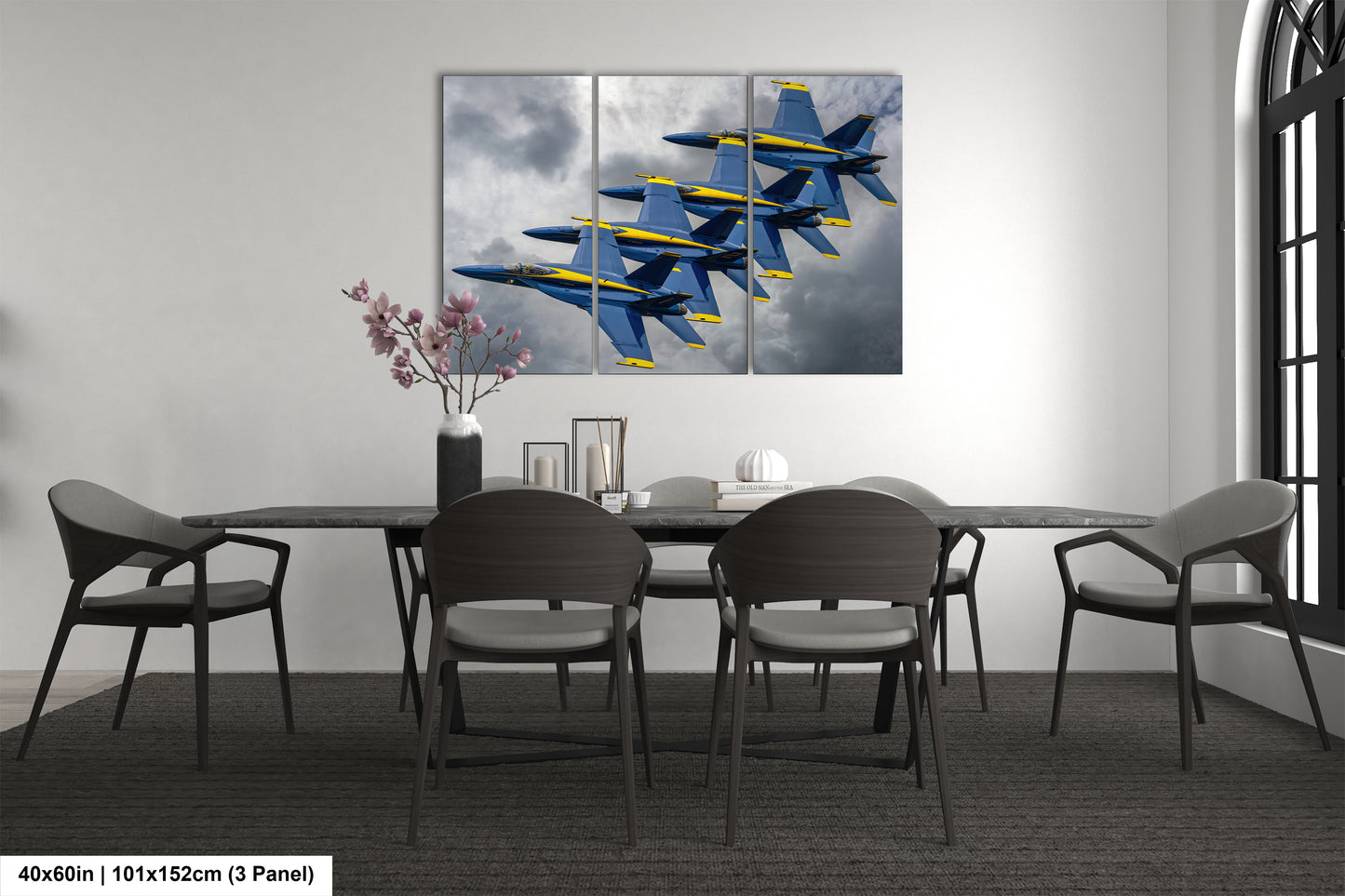 a dining room table with chairs and a painting on the wall