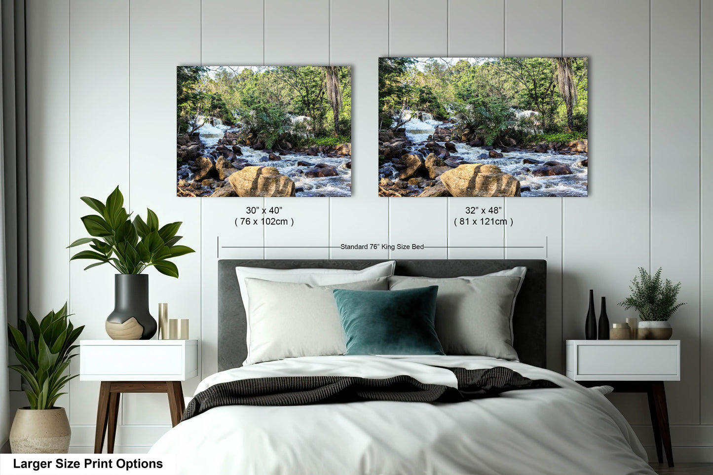 a bed with two pictures on the wall above it