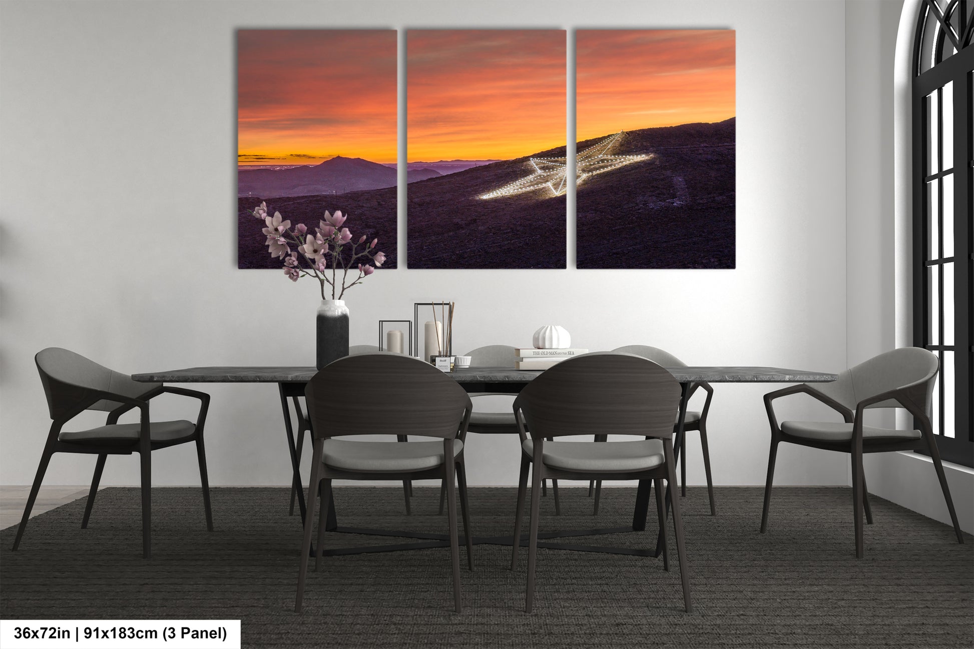 a dining room table with four chairs and a painting on the wall