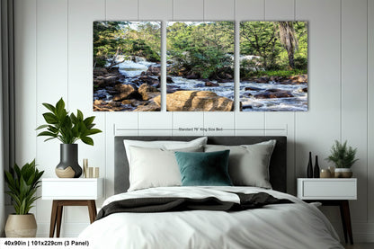 a bed room with a neatly made bed and two paintings on the wall