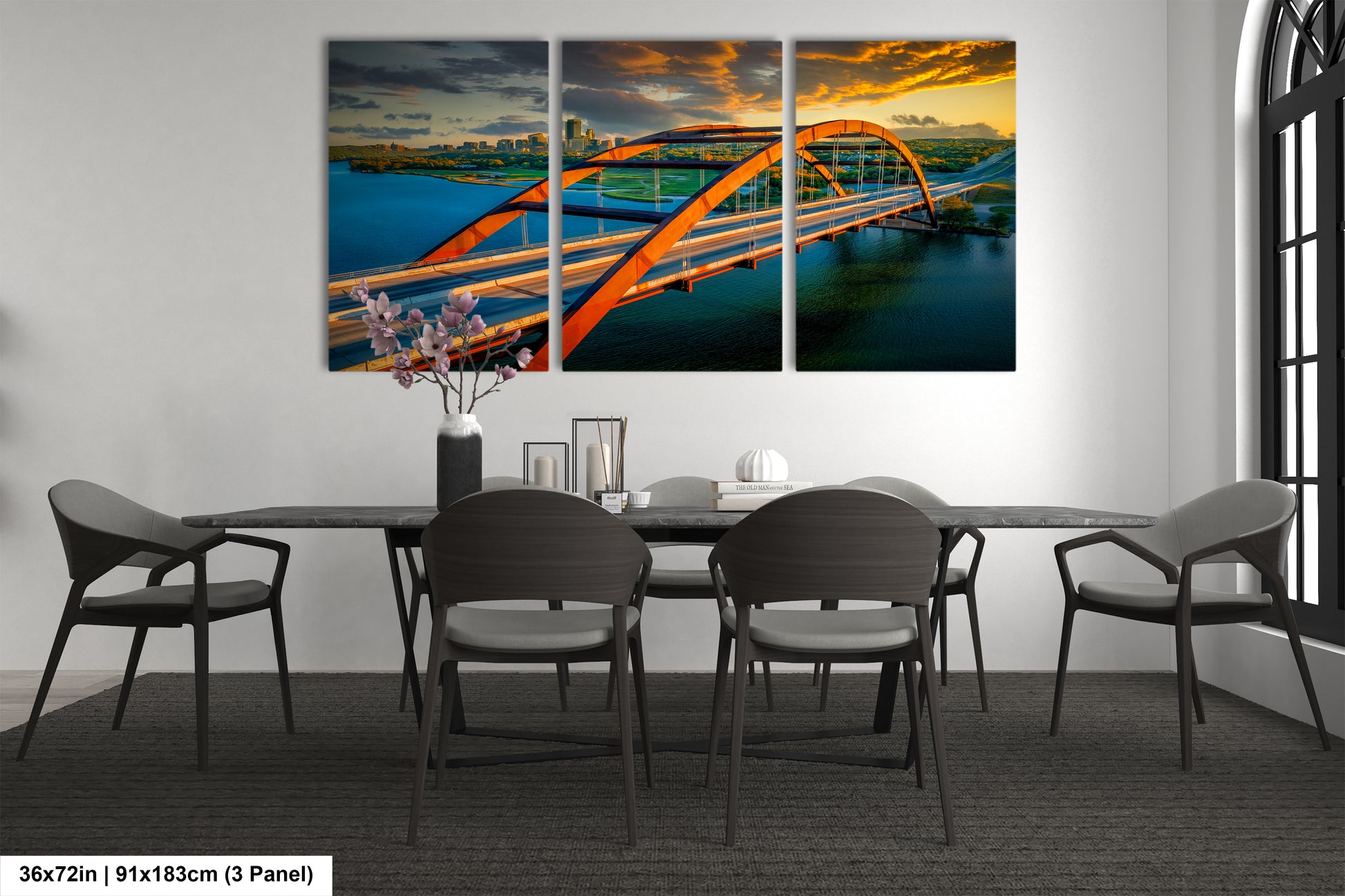 a dining room table with chairs and a painting on the wall