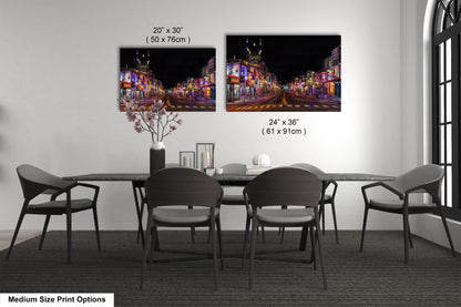 a dining table with four chairs and a vase of flowers