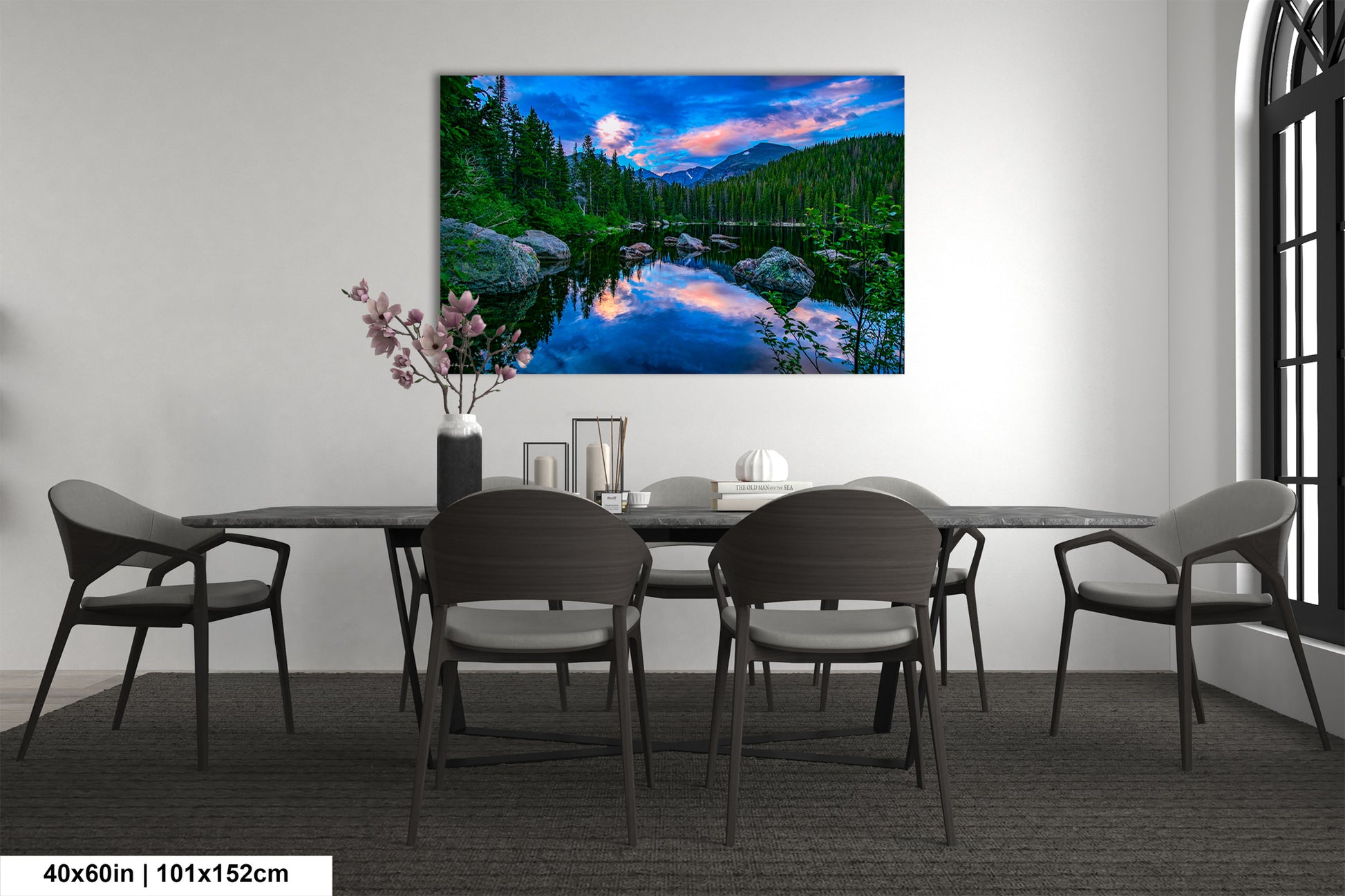 a dining room table with chairs and a painting on the wall