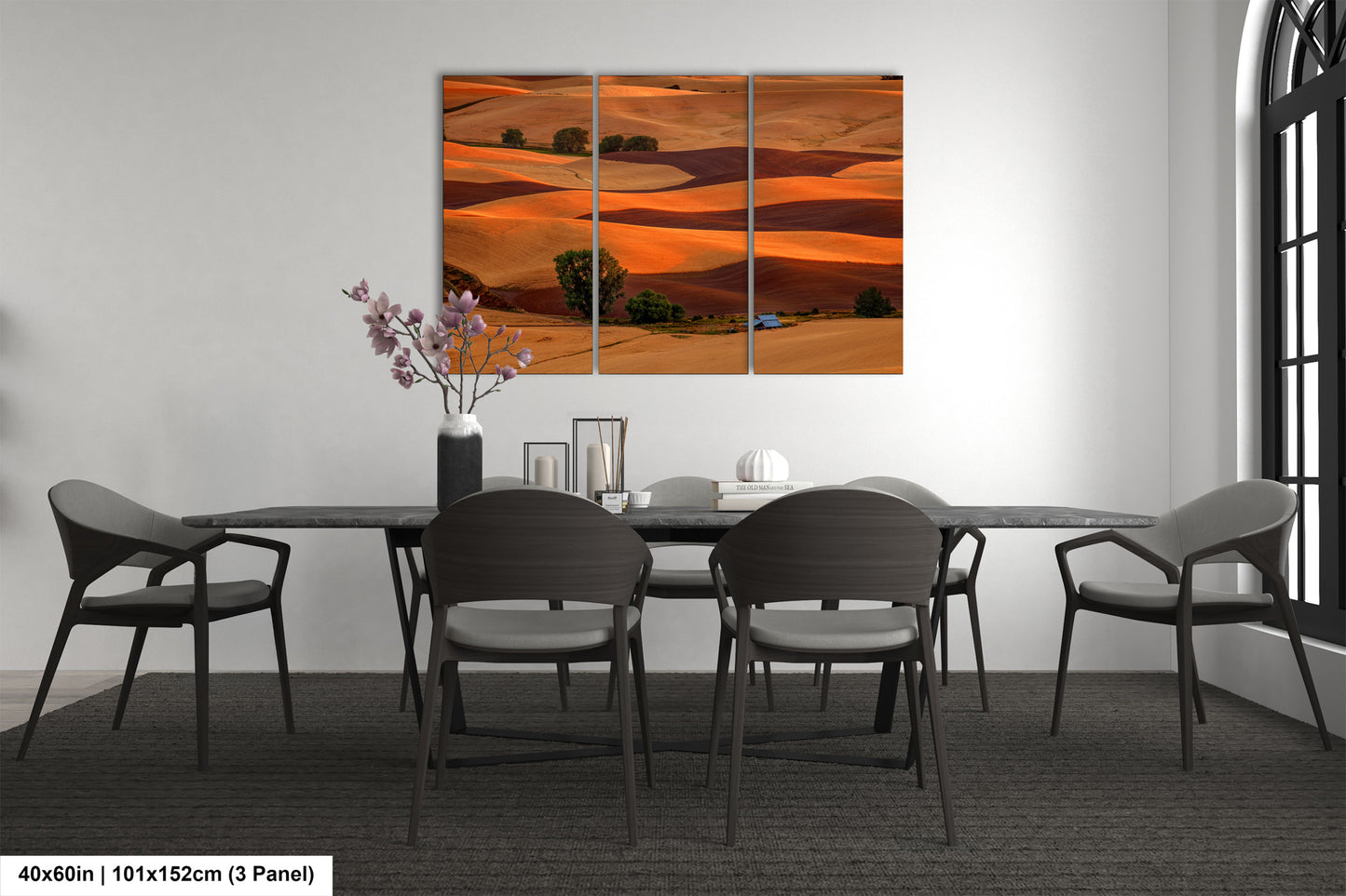 a dining room table with four chairs and a painting on the wall