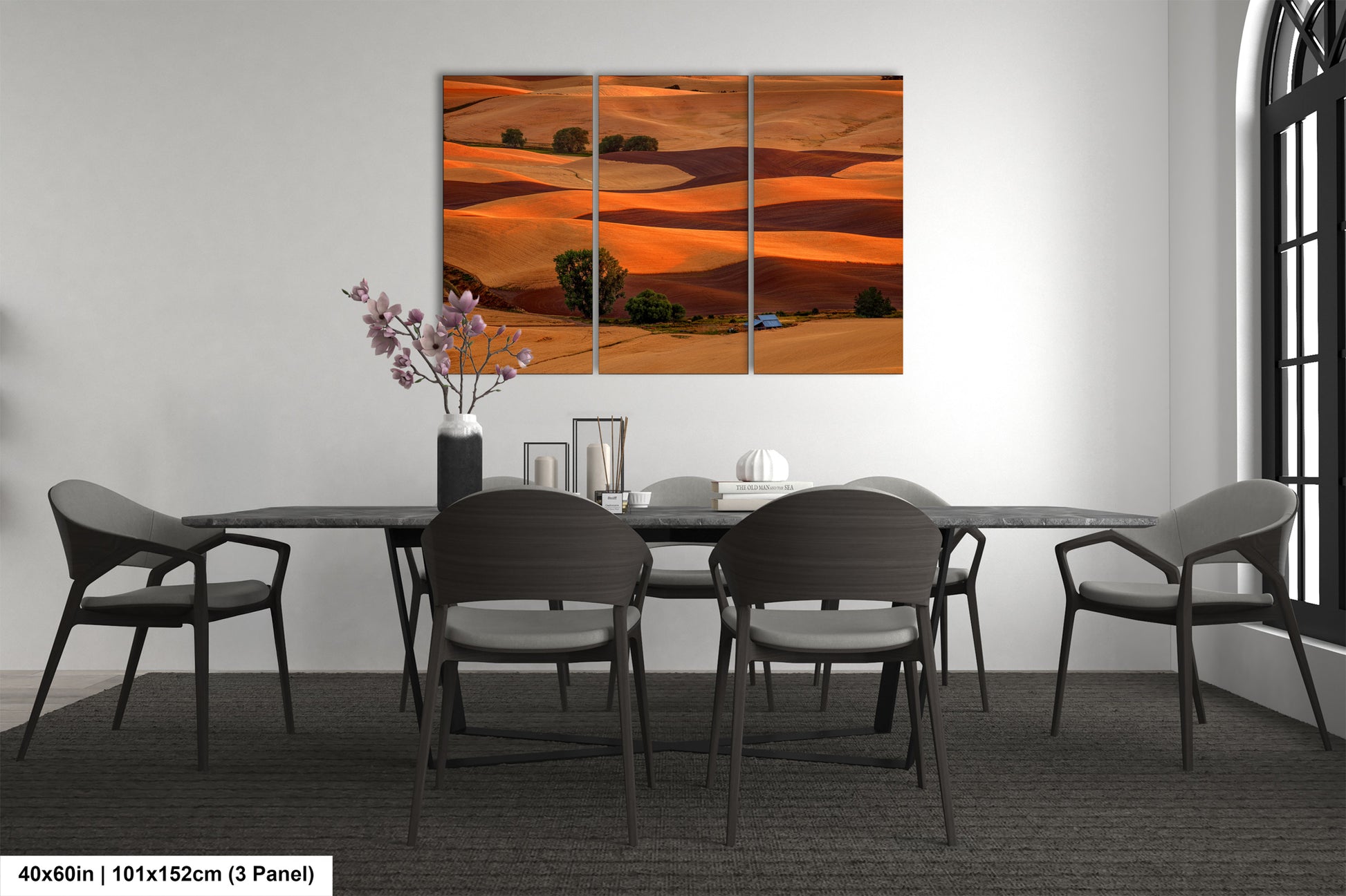 a dining room table with four chairs and a painting on the wall