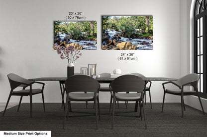 a dining room table with four chairs and a vase of flowers