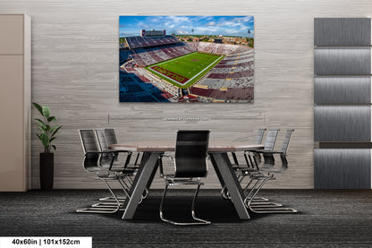 a painting of a football stadium with a table and chairs