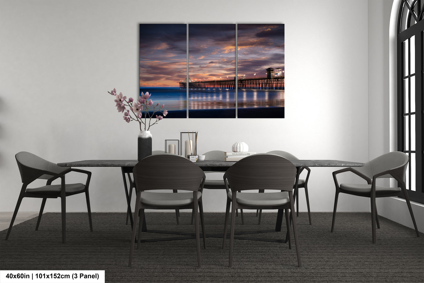 a dining room table with chairs and a painting on the wall