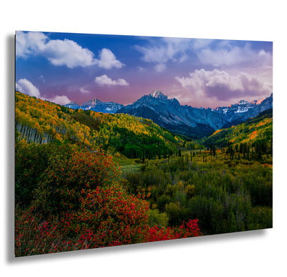 a scenic view of a mountain range in autumn