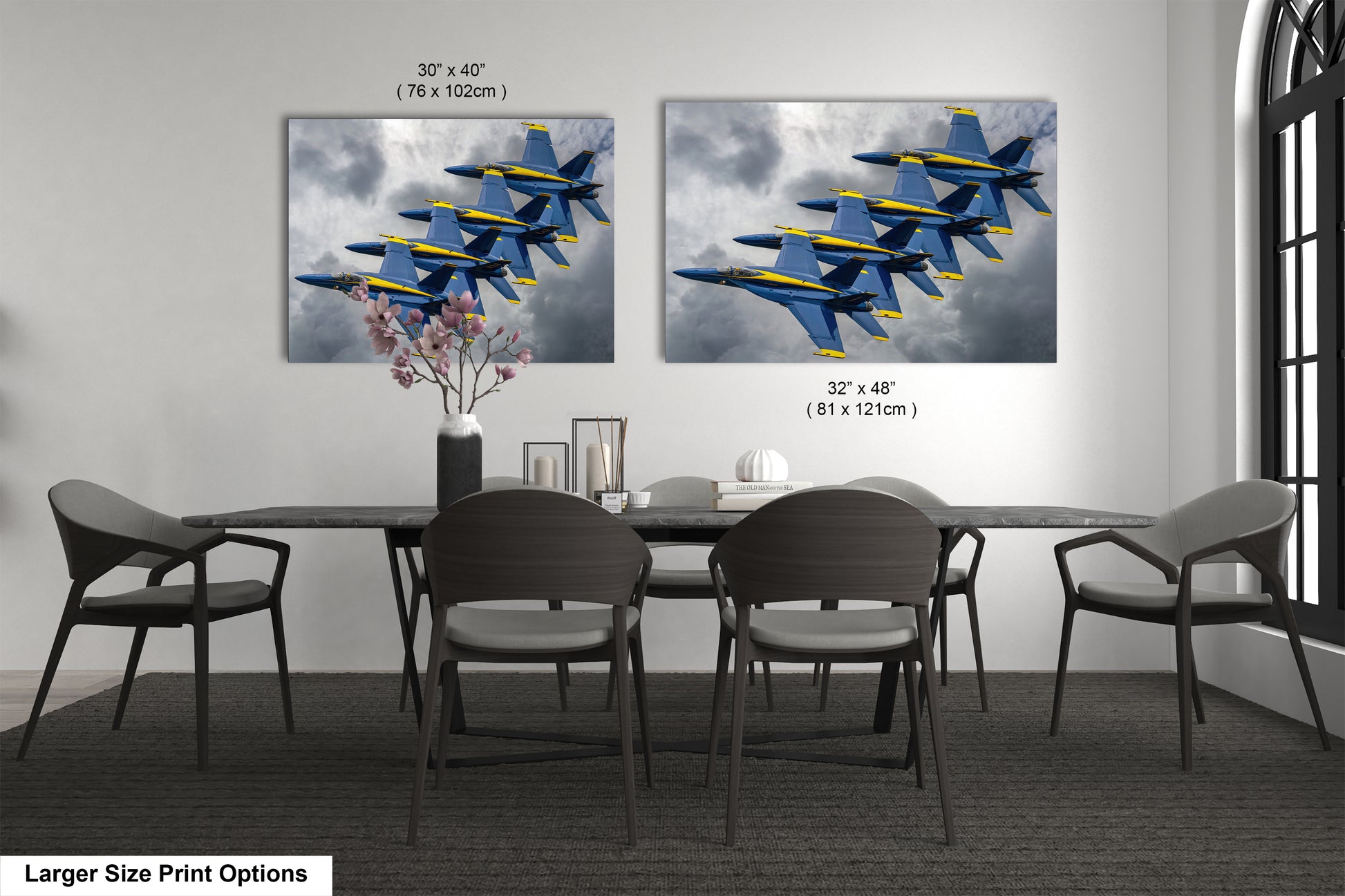 a dining room table with four chairs and a painting of fighter jets