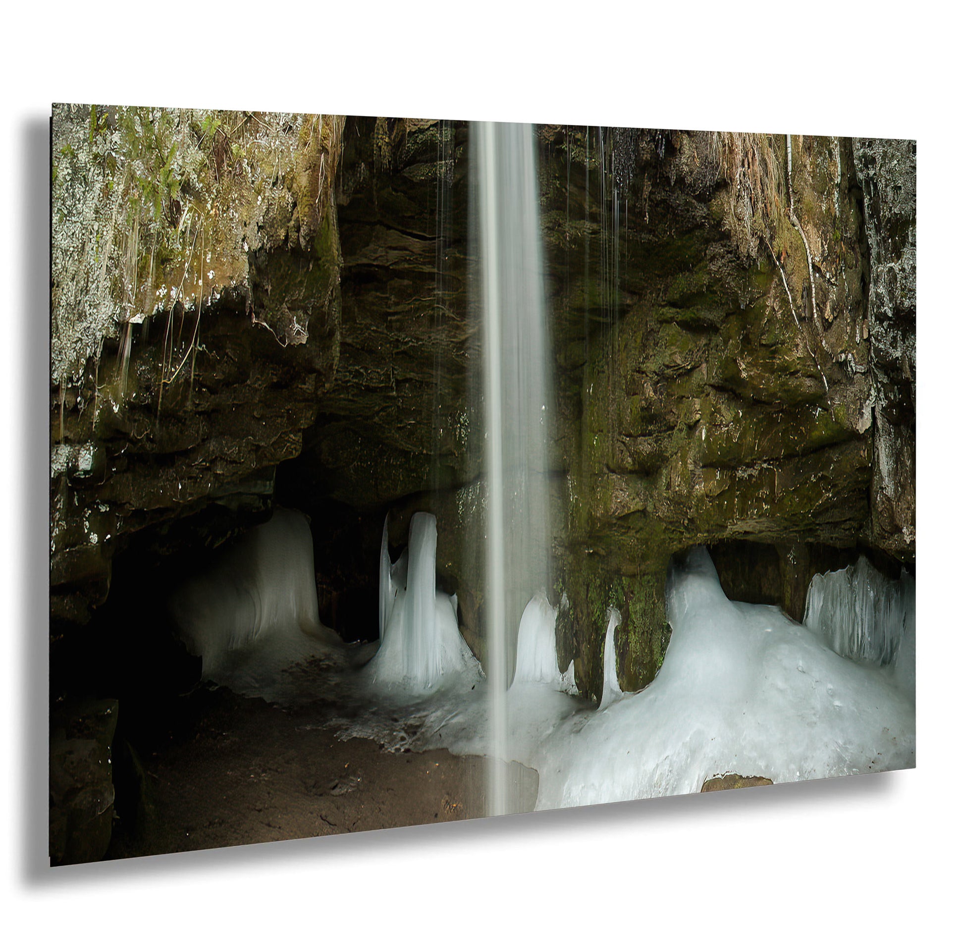 a waterfall is coming out of a cave