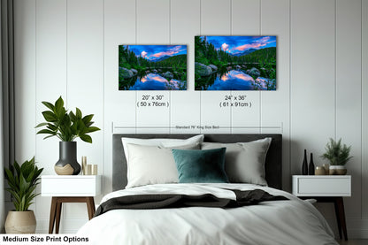 a bed room with a neatly made bed and two pictures on the wall