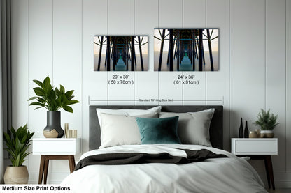 a bedroom with a bed and two pictures on the wall