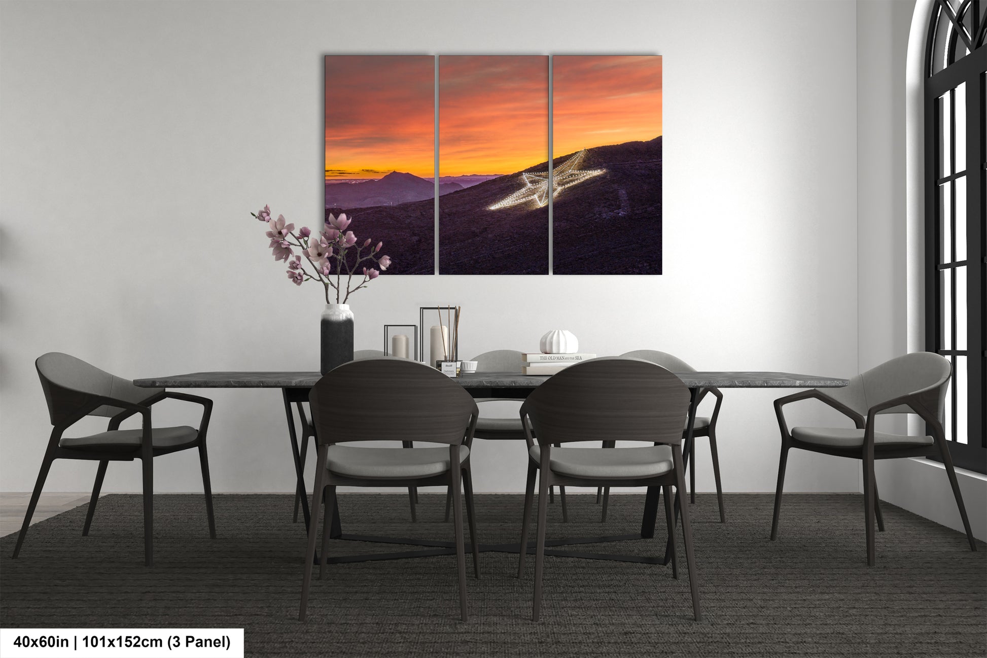 a dining room table with four chairs and a painting on the wall