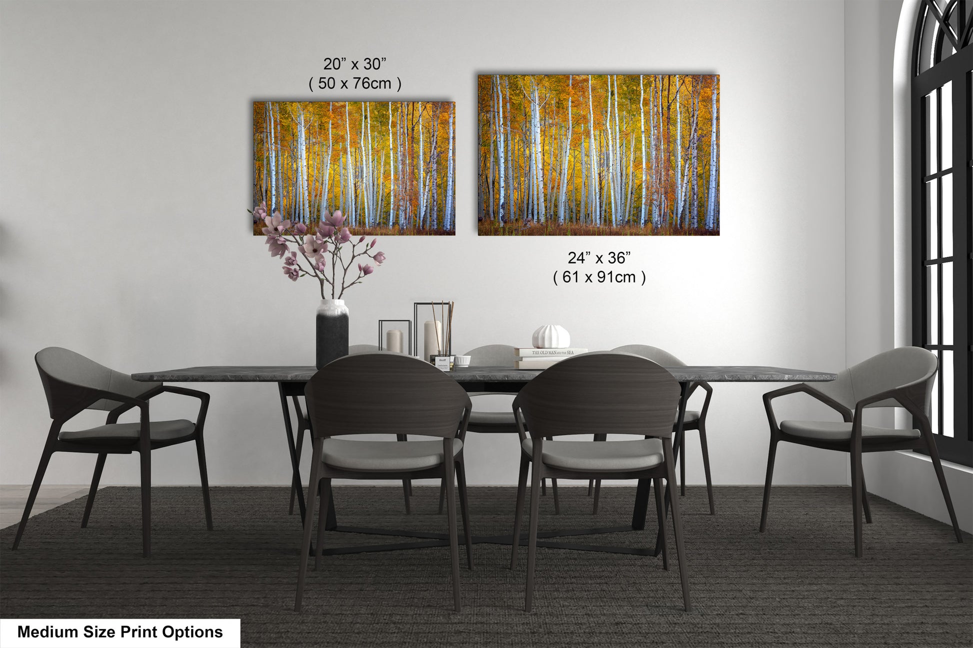 a dining table with four chairs and a vase of flowers