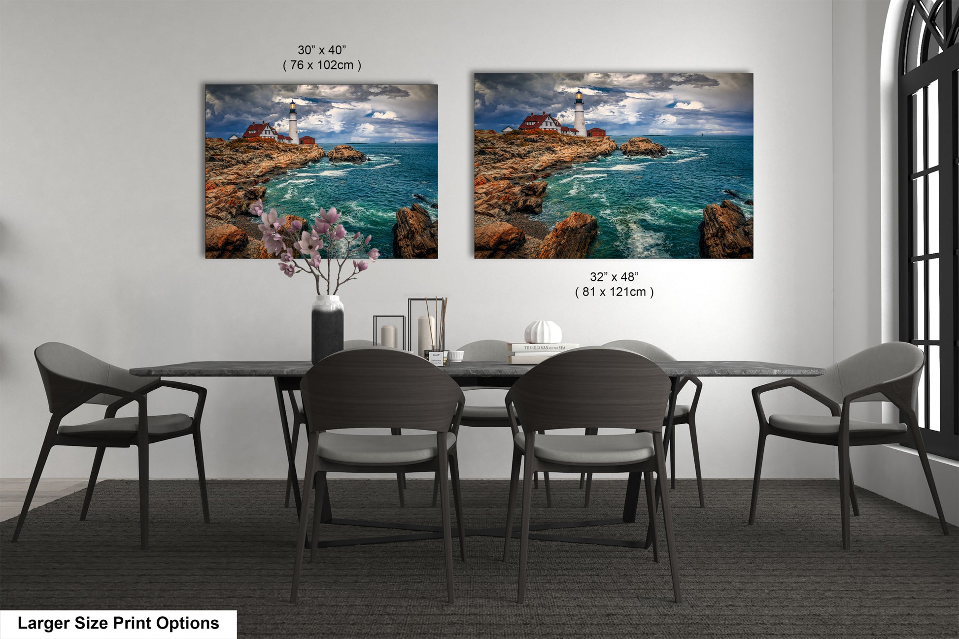 a dining room table with four chairs and two pictures on the wall