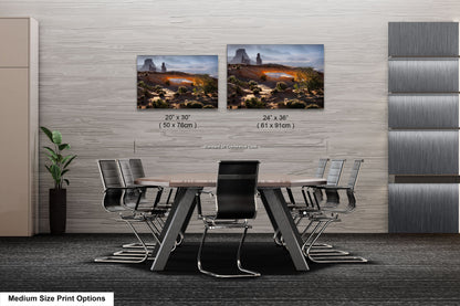 a dining room table with chairs next to a wall with pictures on it