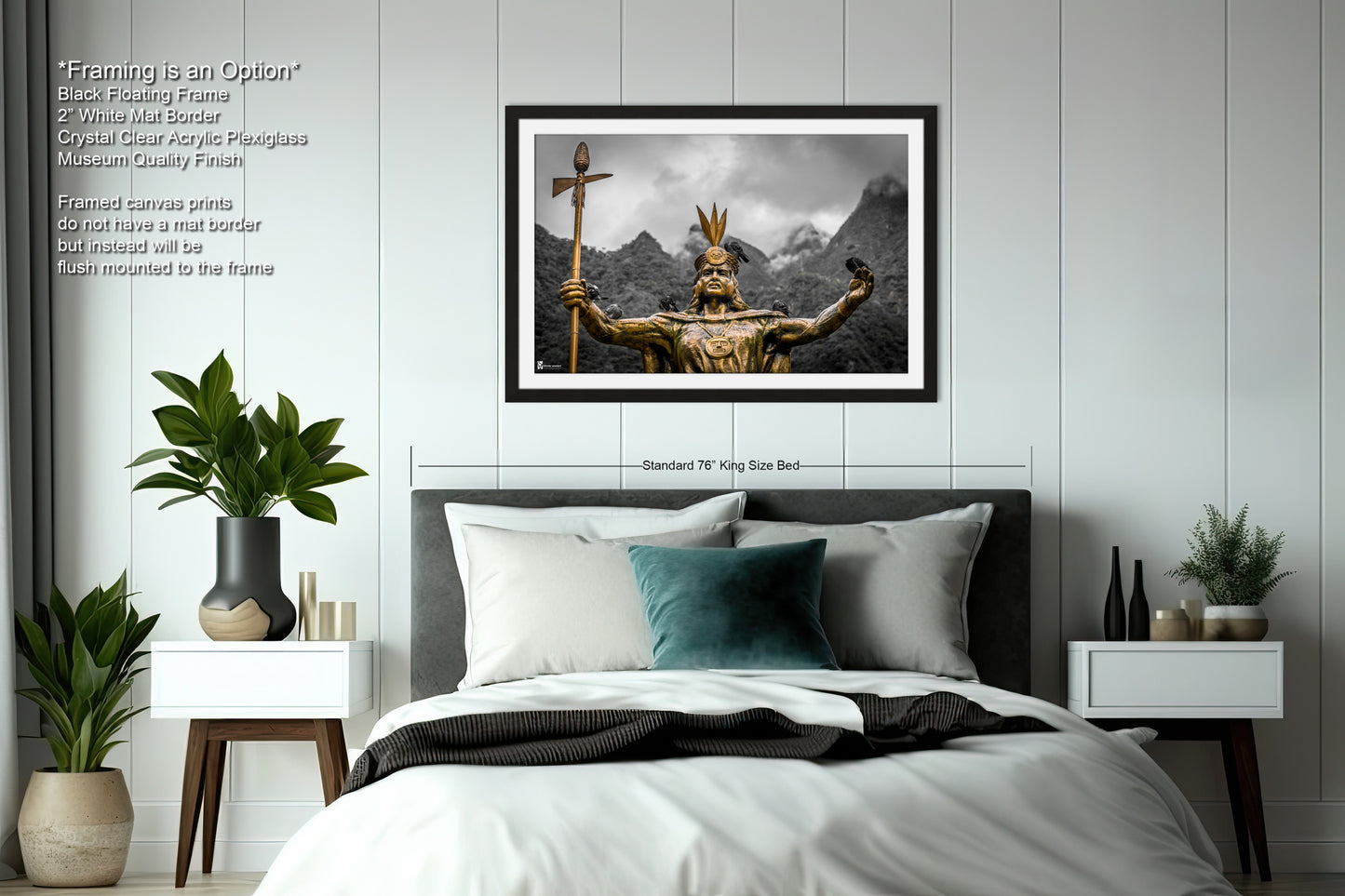 a bed with a white comforter and a picture on the wall above it