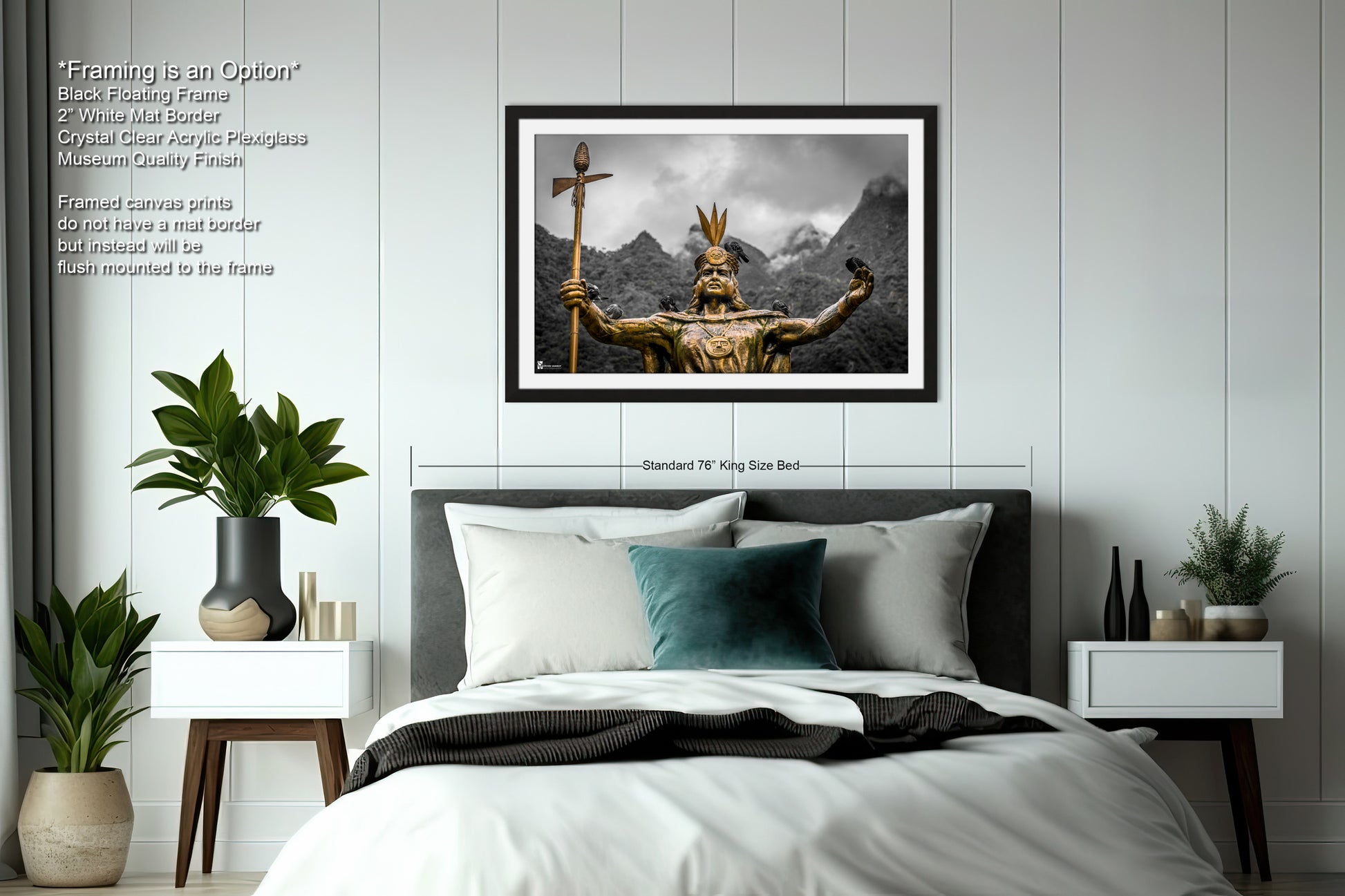 a bed with a white comforter and a picture on the wall above it