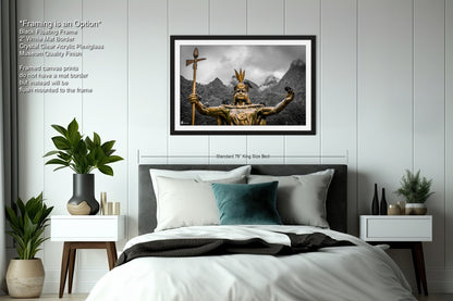 a bed with a white comforter and a picture on the wall above it