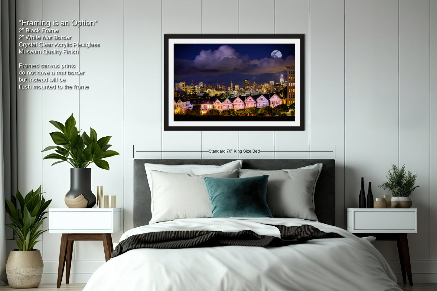 a bedroom with a large bed and a picture hanging above it