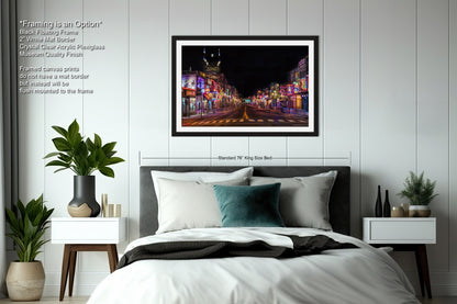 a bedroom with a bed and a picture hanging on the wall
