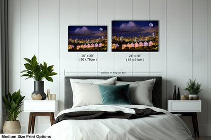 a bed room with a neatly made bed and two pictures on the wall