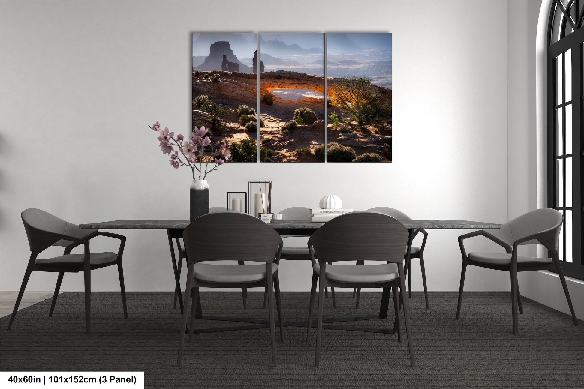 a dining room table with four chairs and a painting on the wall